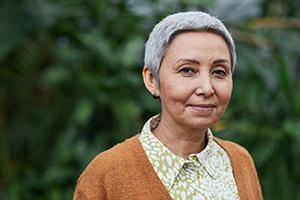A woman with a short gray hair and a subtle smile